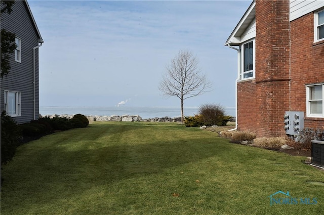 view of yard with a water view and cooling unit