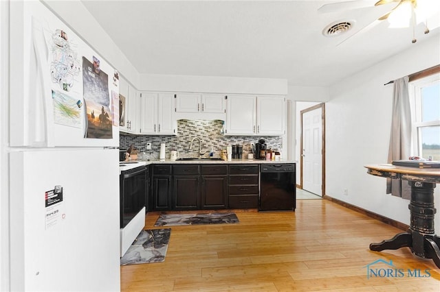 kitchen featuring white appliances, a sink, visible vents, light countertops, and tasteful backsplash