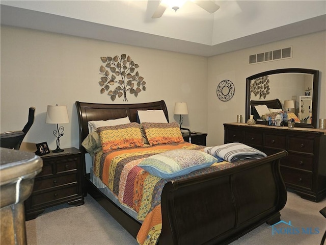 bedroom with ceiling fan, visible vents, and light colored carpet