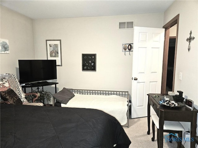 bedroom featuring visible vents and light colored carpet