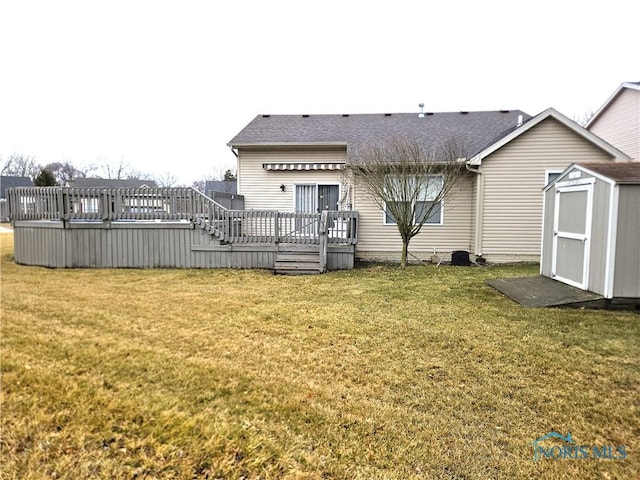 back of property featuring an outbuilding, a lawn, a wooden deck, and a storage shed