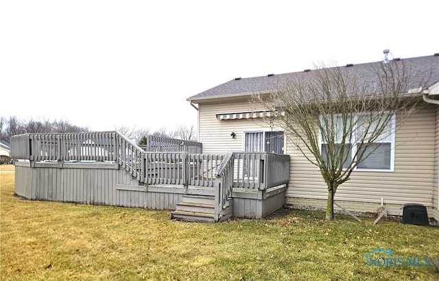 rear view of property with a lawn and a wooden deck