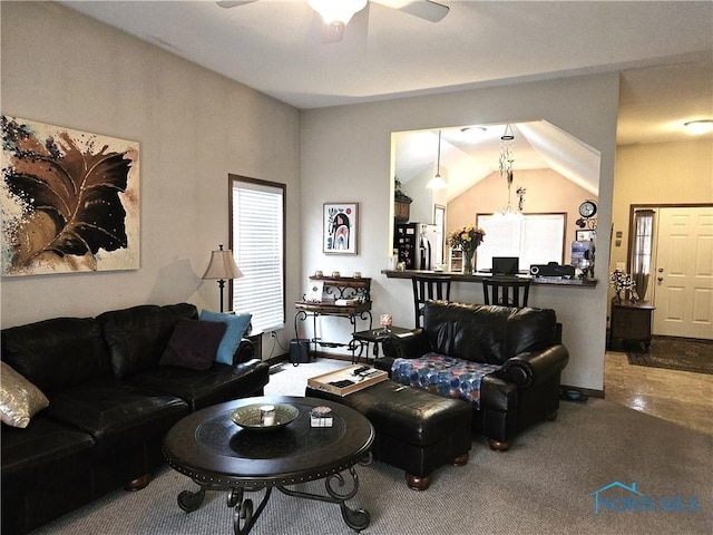 carpeted living room featuring lofted ceiling, a ceiling fan, and baseboards