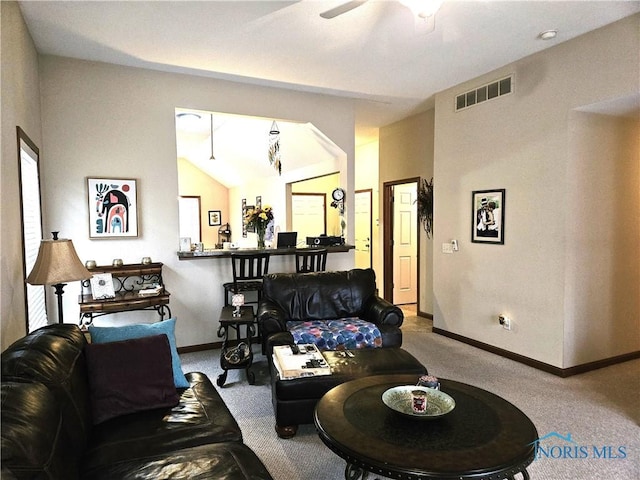 living room with baseboards, visible vents, vaulted ceiling, and carpet flooring