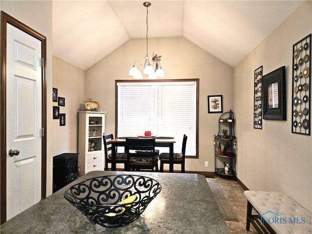 dining room with vaulted ceiling, baseboards, and an inviting chandelier