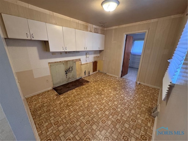 kitchen with baseboards and white cabinets