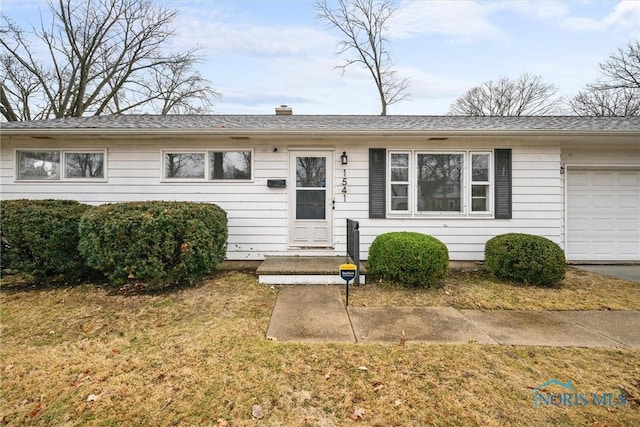 single story home featuring a front lawn and an attached garage