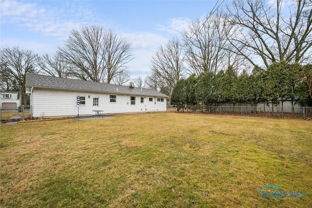 view of yard featuring fence and a patio