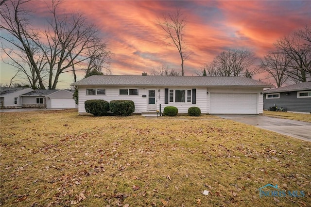 ranch-style home with a front yard, driveway, and an attached garage