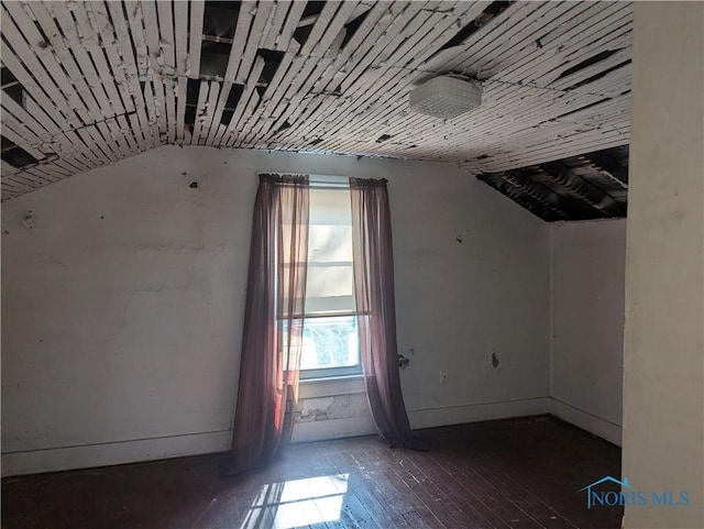 bonus room with wood-type flooring and vaulted ceiling