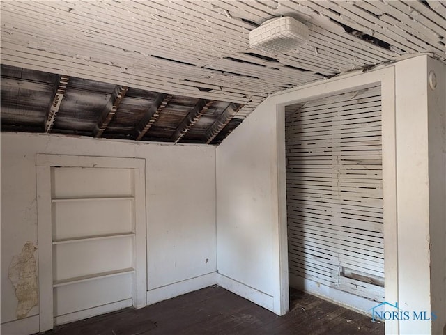 unfurnished bedroom featuring a closet and dark wood-style floors