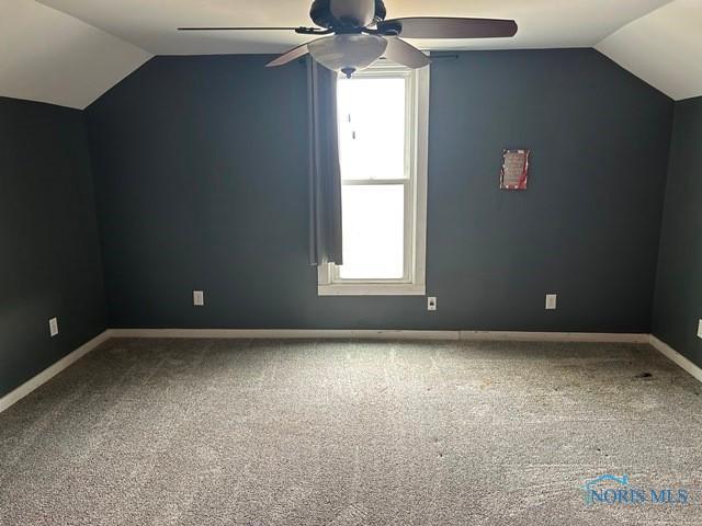 additional living space with vaulted ceiling, carpet, and baseboards