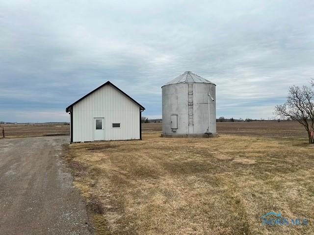 view of outdoor structure with an outbuilding and a rural view