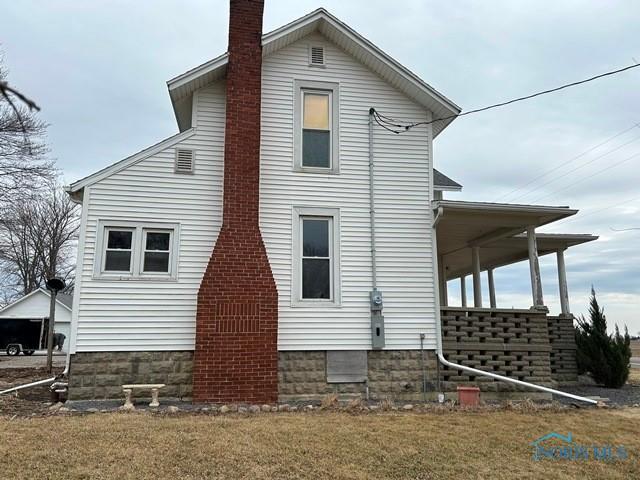 view of home's exterior with a yard and a chimney