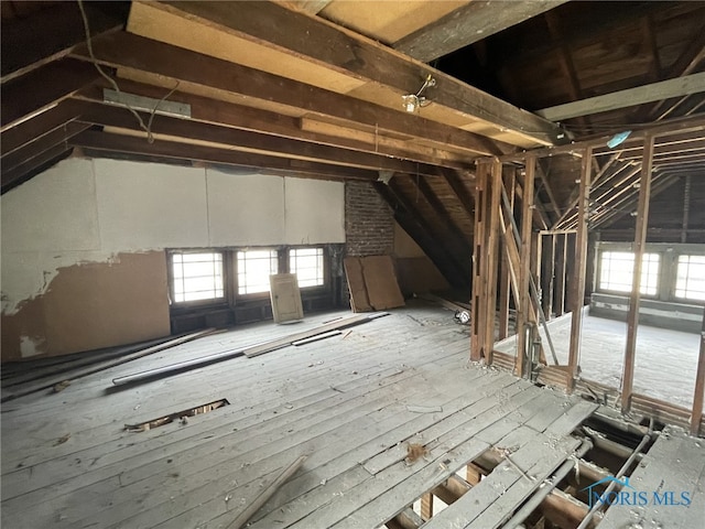 unfinished attic featuring plenty of natural light