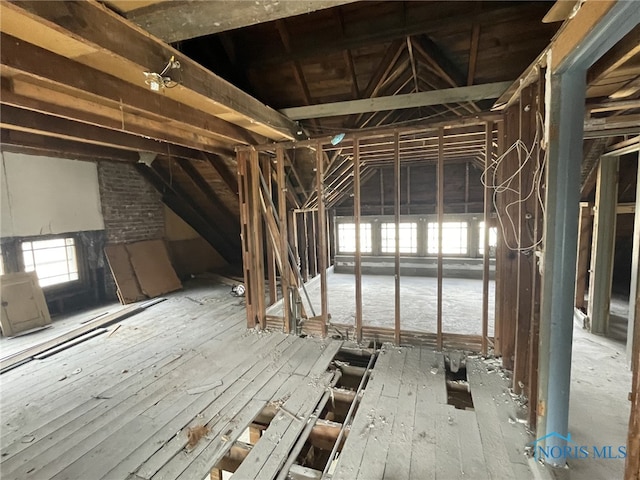 unfinished attic featuring plenty of natural light