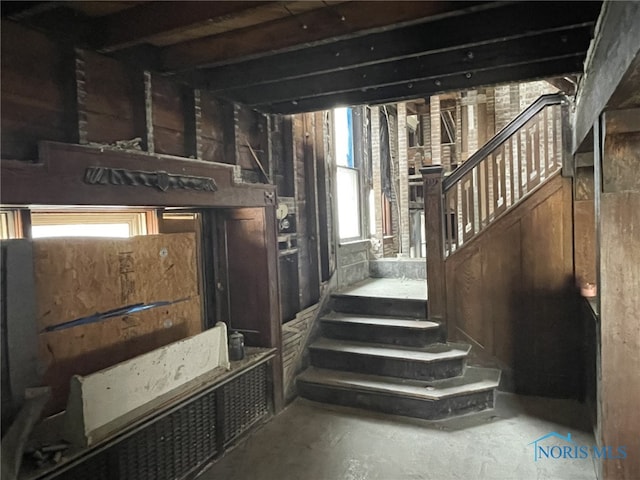 stairs with concrete flooring