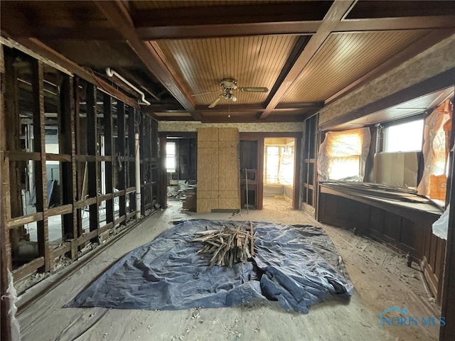 miscellaneous room with beam ceiling and plenty of natural light