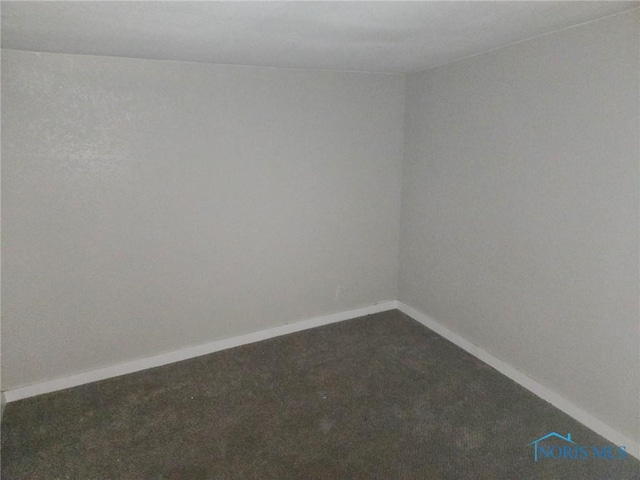 unfurnished room featuring baseboards