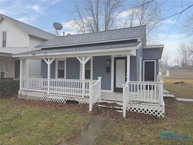 view of front of property with a porch and a shingled roof