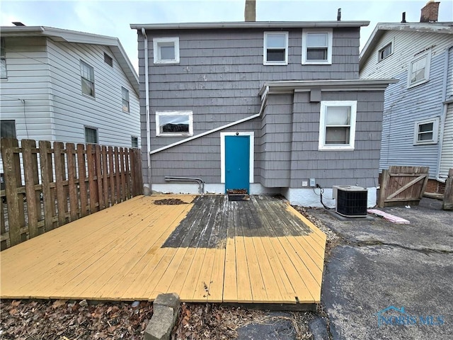 back of house featuring a deck, fence, and central air condition unit