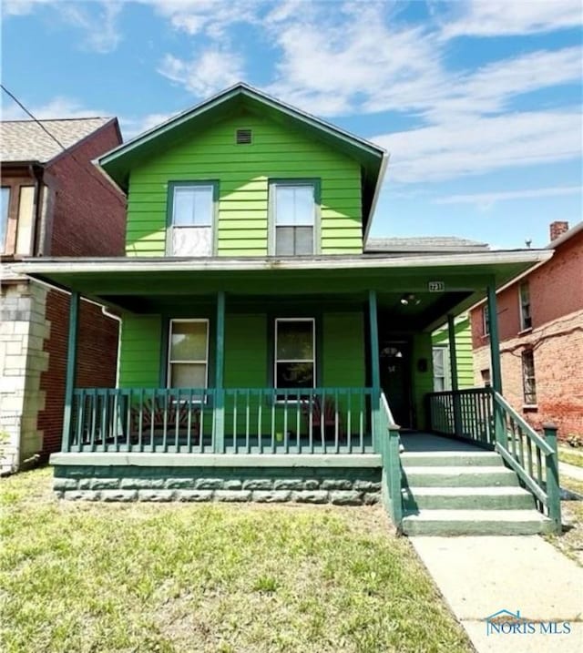 view of front of property with a front lawn and a porch