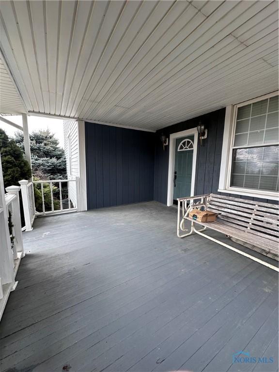 wooden terrace with a carport