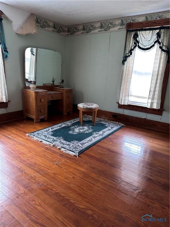 interior space with wood-type flooring and baseboards