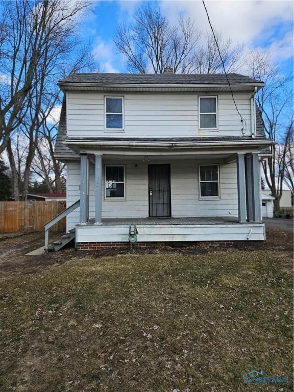 view of front facade with a porch and fence