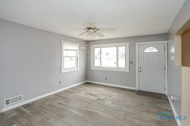 entrance foyer with ceiling fan, wood finished floors, visible vents, and baseboards