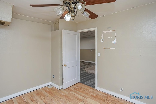 unfurnished bedroom featuring a ceiling fan, light wood-style flooring, and baseboards