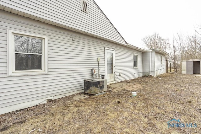 view of property exterior featuring an outbuilding and a shed