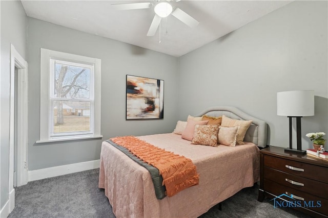 bedroom with baseboards, dark carpet, and a ceiling fan