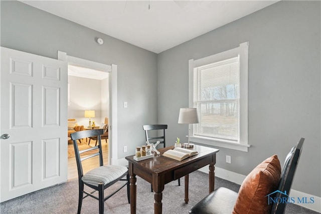 carpeted home office with baseboards