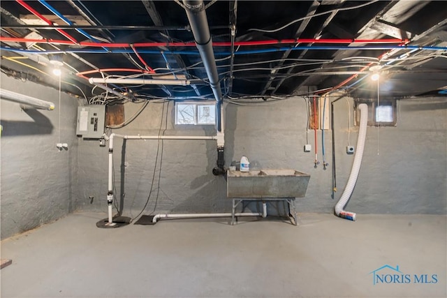 basement featuring a sink and electric panel