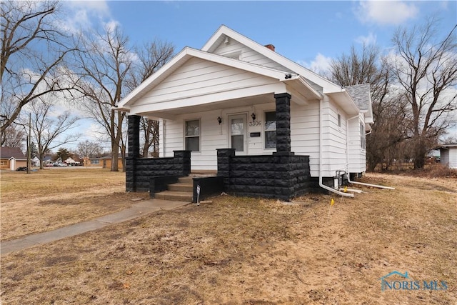 bungalow-style house with covered porch and roof with shingles