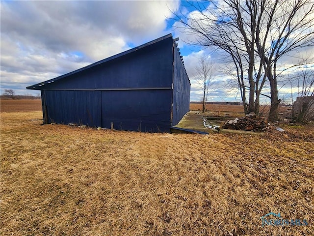 view of side of property featuring an outbuilding