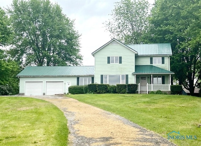 3221 Carrell Rd, Bucyrus, OH 44820 - traditional-style home with a porch, driveway, a front yard, and an attached garage