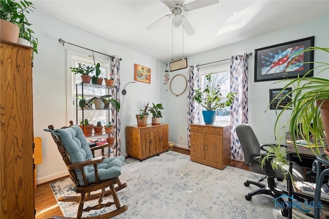 office area featuring ceiling fan, baseboards, and wood finished floors