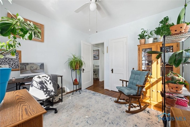 office area featuring ceiling fan, wood finished floors, and baseboards