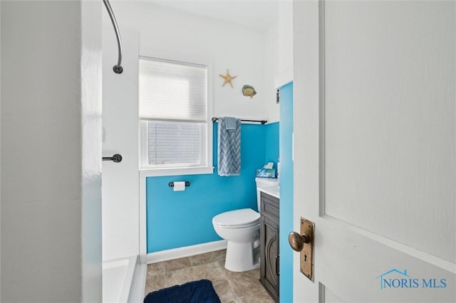 bathroom featuring a shower, vanity, and toilet