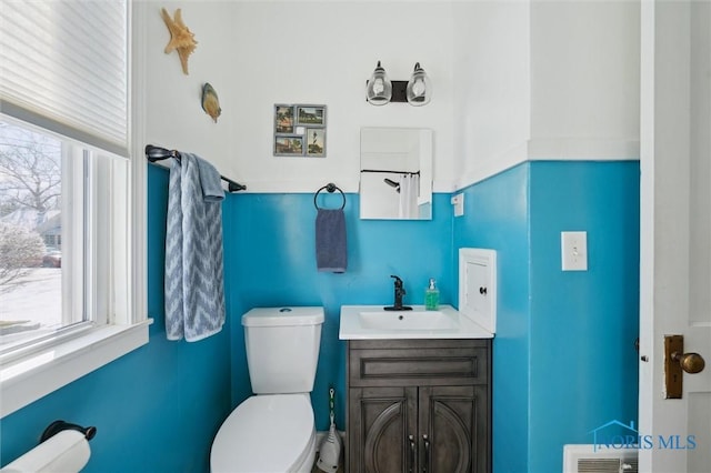 bathroom featuring toilet, visible vents, and vanity