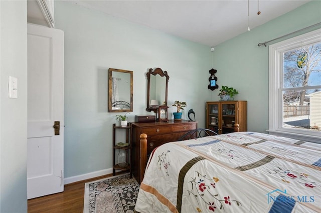 bedroom featuring wood finished floors and baseboards