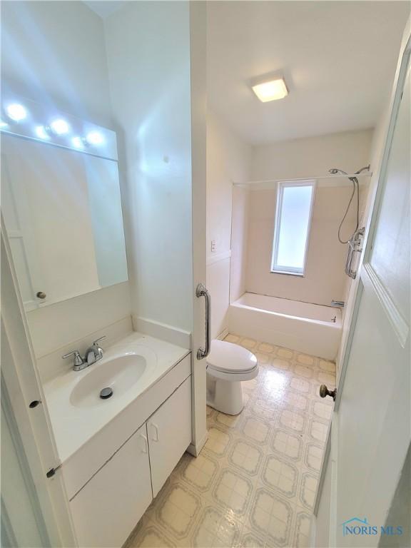 full bathroom with  shower combination, vanity, toilet, and tile patterned floors