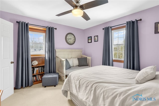 carpeted bedroom with ceiling fan