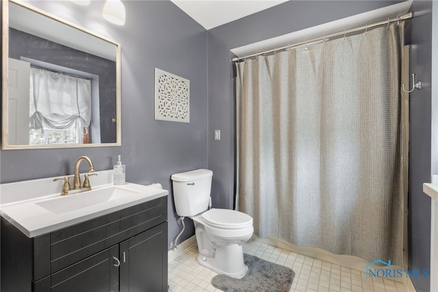 bathroom with curtained shower, tile patterned flooring, toilet, vanity, and baseboards