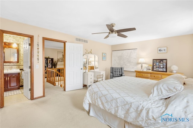 bedroom with baseboards, visible vents, a ceiling fan, and light colored carpet