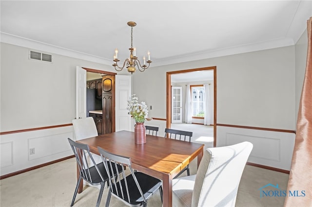 5605 Weckerly Rd, Whitehouse, OH 43571 - dining room with crown molding, light colored carpet, a chandelier, and visible vents
