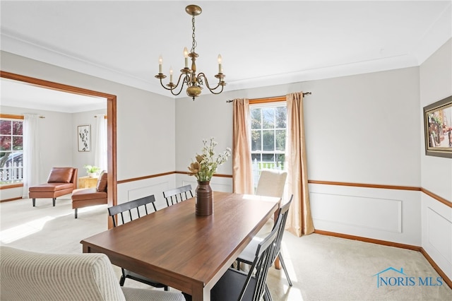 5605 Weckerly Rd, Whitehouse, OH 43571 - dining space with an inviting chandelier, a wainscoted wall, ornamental molding, and light colored carpet