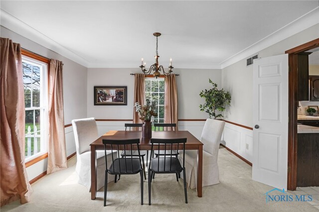 5605 Weckerly Rd, Whitehouse, OH 43571 - dining room with visible vents, ornamental molding, light carpet, a wainscoted wall, and a notable chandelier